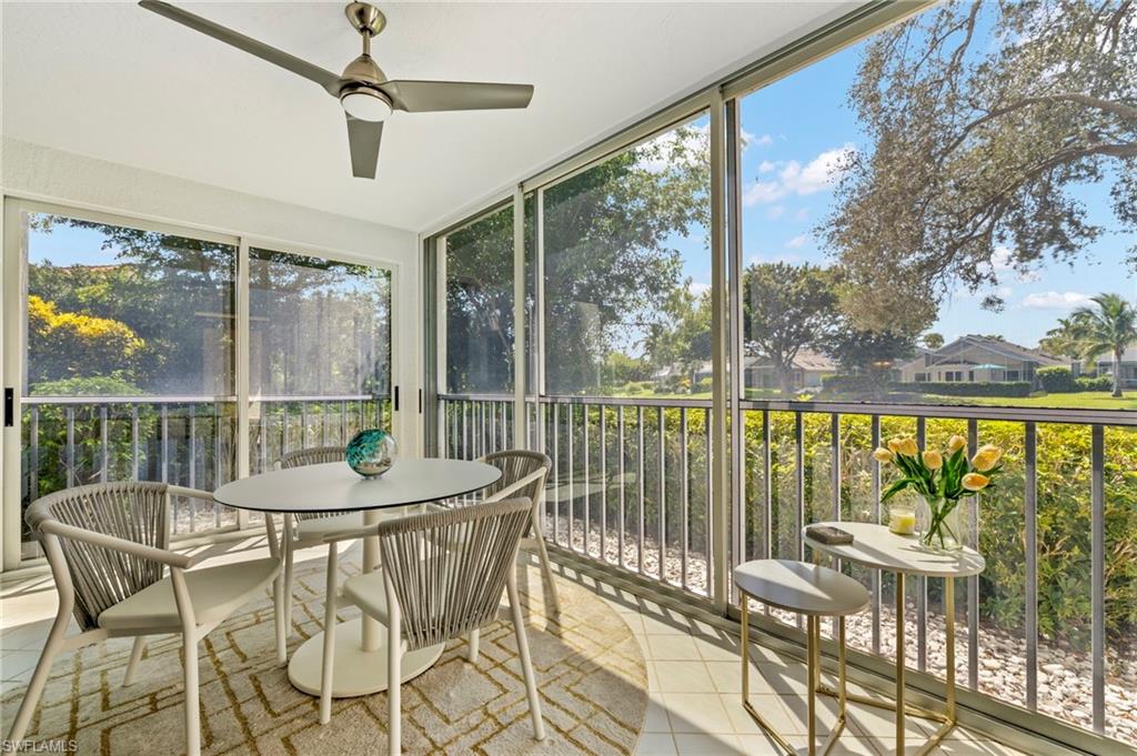 793 Willowbrook Drive, Unit 104 Naples, FL 34108 - Photo 16 of 38 a dining room with furniture water view and a floor to ceiling window