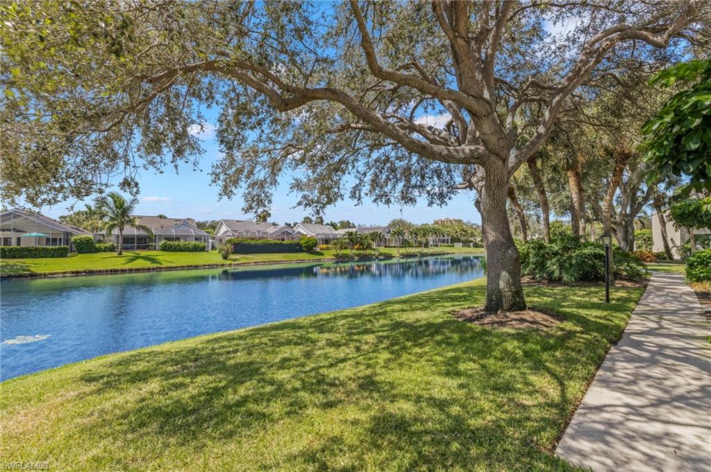 793 Willowbrook Drive, Unit 104 Naples, FL 34108 - Photo 17 of 38 a view of a lake with houses in the background