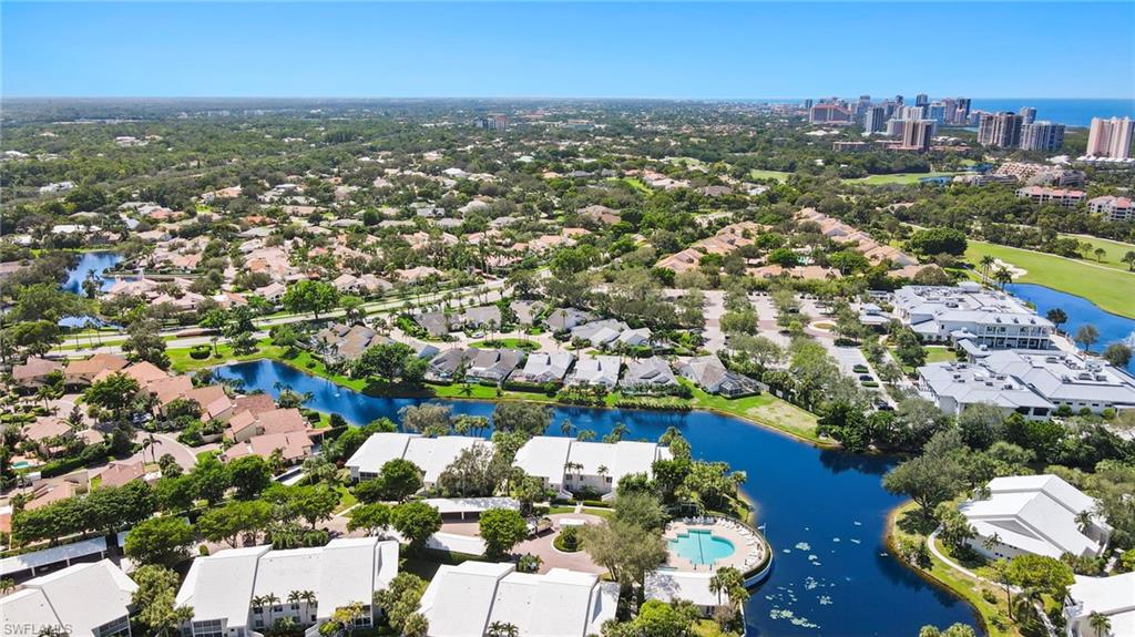 793 Willowbrook Drive, Unit 104 Naples, FL 34108 - Photo 2 of 38 an aerial view of residential houses with outdoor space and swimming pool
