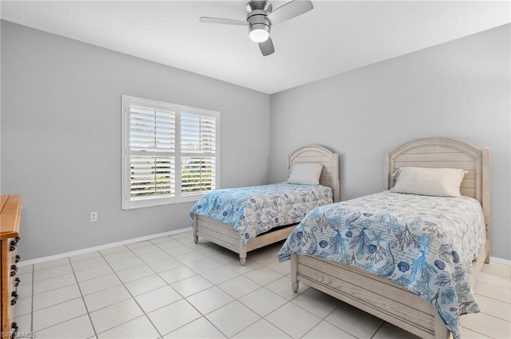 793 Willowbrook Drive, Unit 104 Naples, FL 34108 - Photo 21 of 38 a bedroom with two beds and window