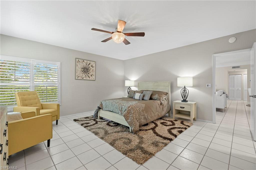 793 Willowbrook Drive, Unit 104 Naples, FL 34108 - Photo 24 of 38 a bedroom with a bed and window