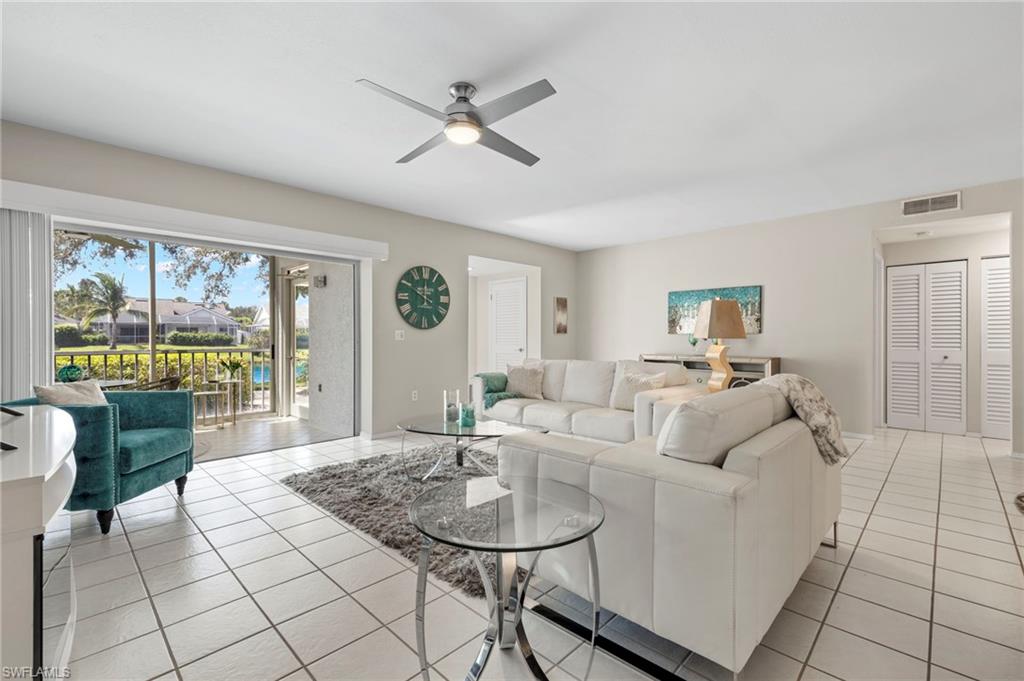 793 Willowbrook Drive, Unit 104 Naples, FL 34108 - Photo 38 of 38 a living room with furniture and a large window