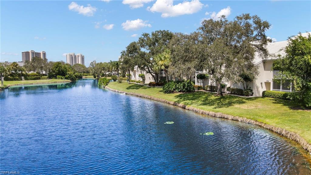 793 Willowbrook Drive, Unit 104 Naples, FL 34108 - Photo 4 of 38 a view of a house with yard and lake view