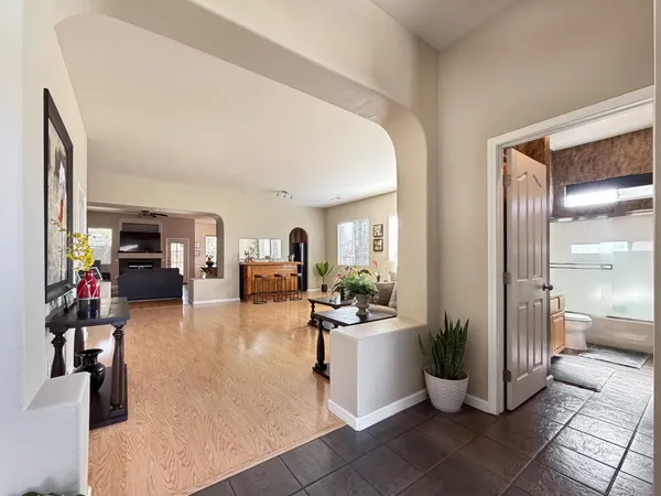 a living room with furniture kitchen and a table