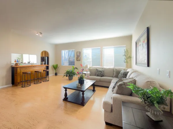 a living room with furniture kitchen and a table
