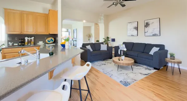 a living room with furniture and a wooden floor