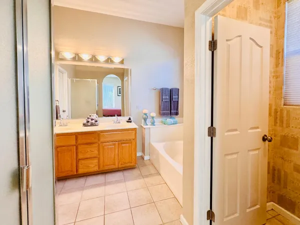 a bedroom with a bed and a flat tv screen on dresser