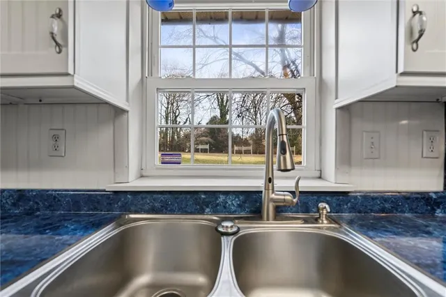 a kitchen with a sink and a window