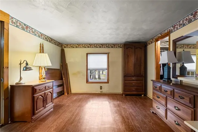 a kitchen with stainless steel appliances granite countertop a stove and a wooden floors