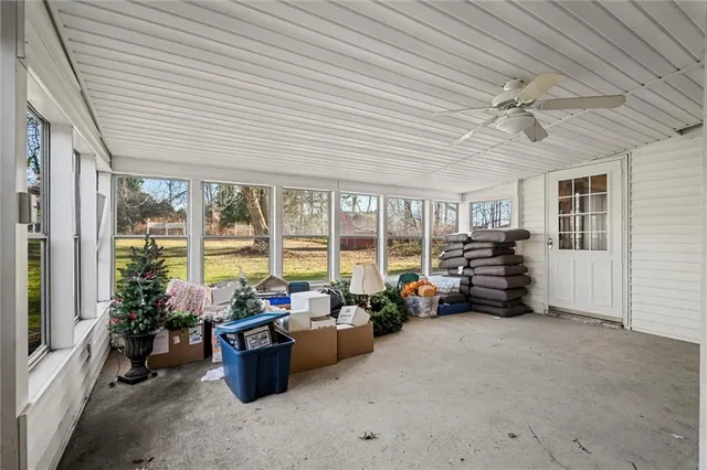 a living room with furniture and floor to ceiling window