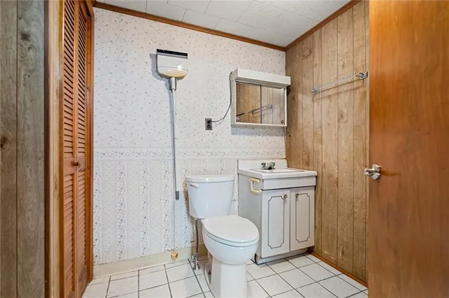 a bathroom with a toilet a sink and mirror