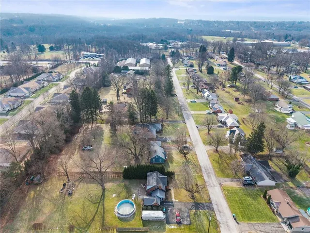 an aerial view of residential houses with swimming pool and outdoor space