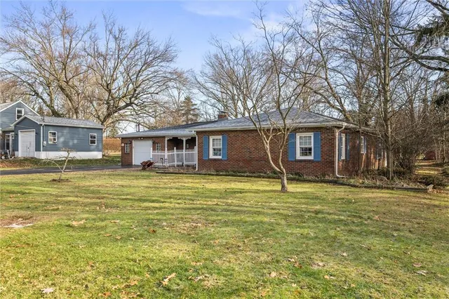 a house with swimming pool in front of it