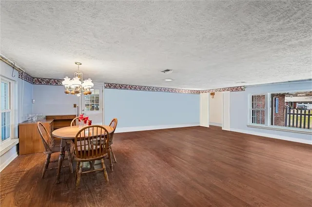 a dining room with furniture and chandelier