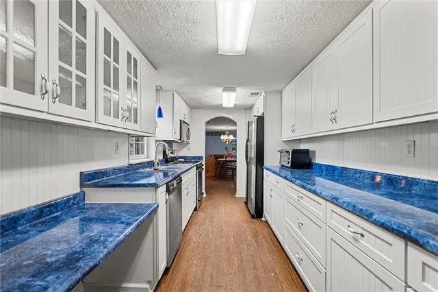 a large kitchen with stainless steel appliances granite countertop a large counter top