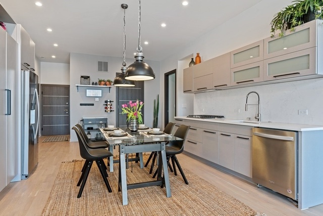 1708 West Cermak Road, Unit 2E Chicago, IL 60608 - Photo 13 of 49 a kitchen with stainless steel appliances kitchen island granite countertop a sink and cabinets