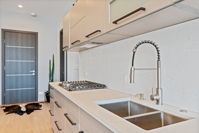 1708 West Cermak Road, Unit 2E Chicago, IL 60608 - Photo 20 of 49 a kitchen with a sink and a refrigerator