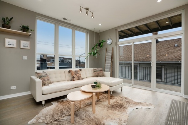 1708 West Cermak Road, Unit 2E Chicago, IL 60608 - Photo 3 of 49 a living room with furniture and a large window