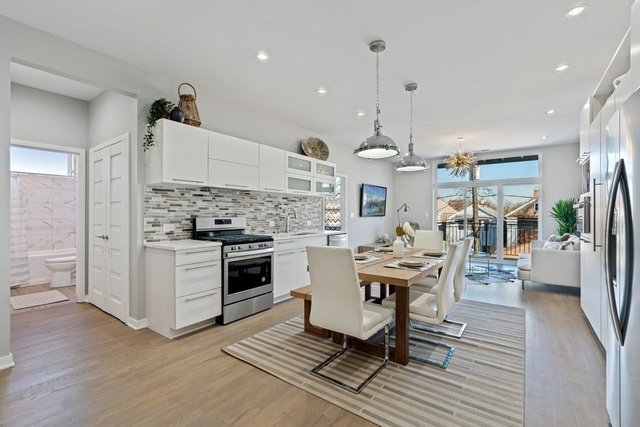 1708 West Cermak Road, Unit 2E Chicago, IL 60608 - Photo 23 of 49 a kitchen with stainless steel appliances a dining table chairs stove and white cabinets