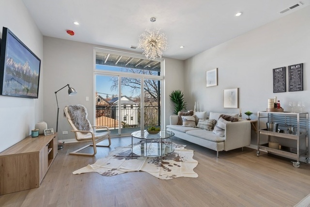 1708 West Cermak Road, Unit 2E Chicago, IL 60608 - Photo 24 of 49 a living room with furniture or chandelier and a wooden floor