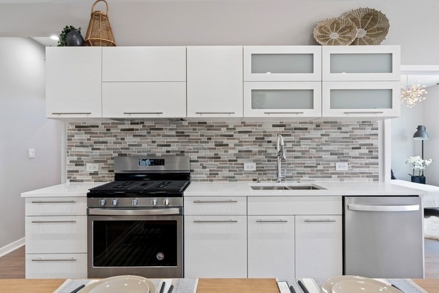 1708 West Cermak Road, Unit 2E Chicago, IL 60608 - Photo 29 of 49 a kitchen with cabinets appliances and a sink