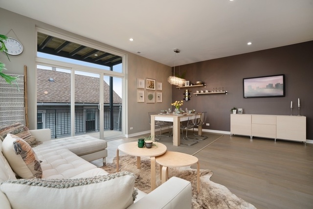 1708 West Cermak Road, Unit 2E Chicago, IL 60608 - Photo 4 of 49 a living room with furniture and a large window
