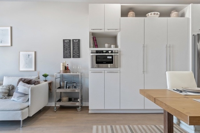 1708 West Cermak Road, Unit 2E Chicago, IL 60608 - Photo 31 of 49 a living room with furniture a flat screen tv and a table