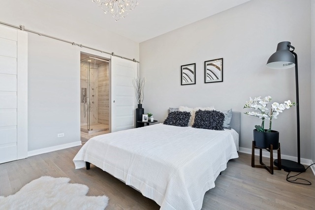 1708 West Cermak Road, Unit 2E Chicago, IL 60608 - Photo 34 of 49 a bedroom with a bed and a table