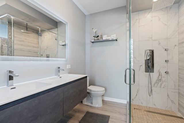 1708 West Cermak Road, Unit 2E Chicago, IL 60608 - Photo 35 of 49 a bathroom with a sink a toilet and shower