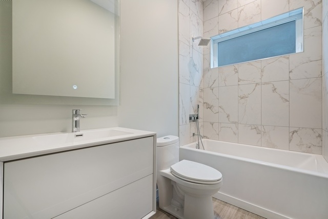 1708 West Cermak Road, Unit 2E Chicago, IL 60608 - Photo 45 of 49 a bathroom with a sink a toilet and bathtub
