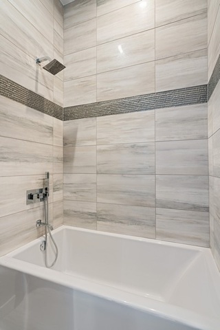1708 West Cermak Road, Unit 2E Chicago, IL 60608 - Photo 46 of 49 a bathroom with a shower and a bath tub