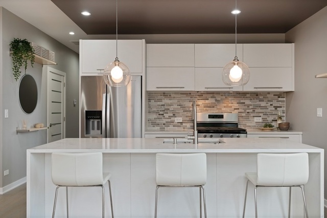 1708 West Cermak Road, Unit 2E Chicago, IL 60608 - Photo 8 of 49 a kitchen with a sink a microwave a stove and refrigerator