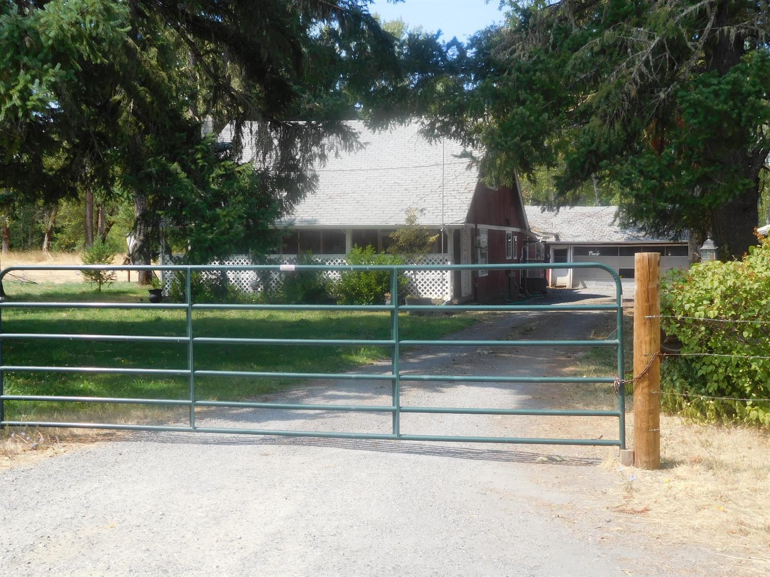 2180 Dick George Road Cave Junction, OR 97523 - Photo 2 of 34 View of home at the driveway entrance. T