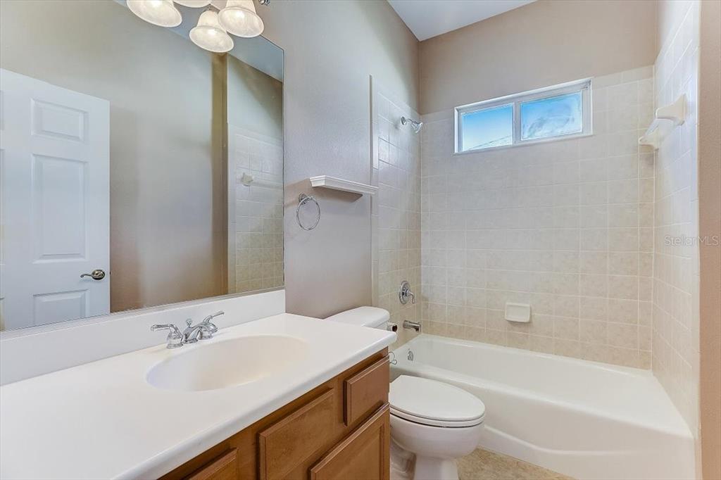 6214 Warbler Lane Lakewood Ranch, FL 34202 - Photo 24 of 40 a bathroom with a sink a toilet and shower