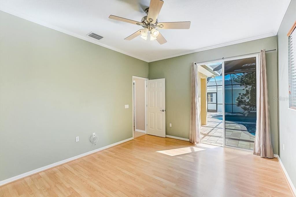 6214 Warbler Lane Lakewood Ranch, FL 34202 - Photo 27 of 40 an empty room with wooden floor and fan