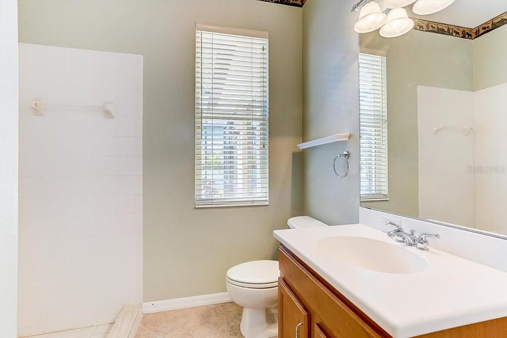 6214 Warbler Lane Lakewood Ranch, FL 34202 - Photo 29 of 40 a bathroom with a granite countertop sink toilet and mirror