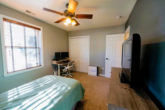 a bedroom with a bed and a chandelier