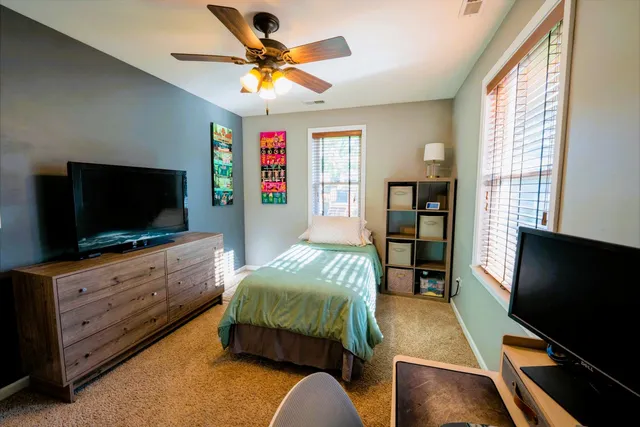 a bedroom with furniture and a flat screen tv