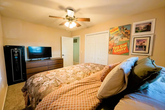a bedroom with a bed and a flat screen tv