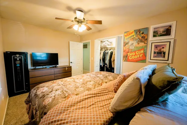 a bedroom with a bed and a flat screen tv