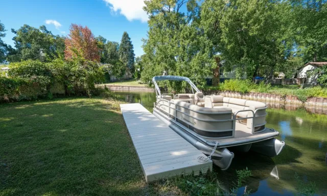 a view of a swimming pool with a patio and backyard
