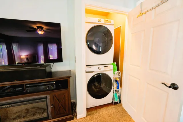 a view of a living room with washer and dryer