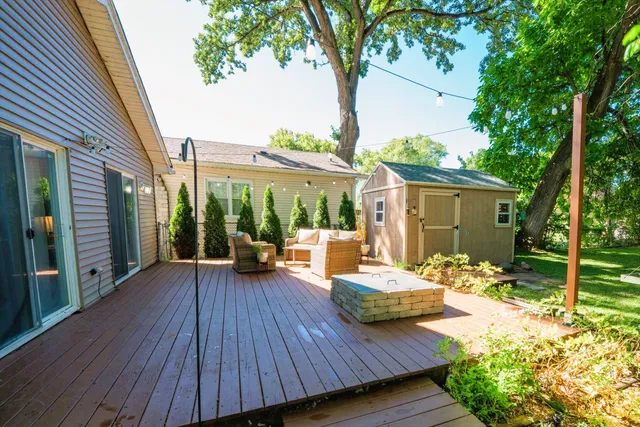 a view of a patio with wooden floor table and chairs