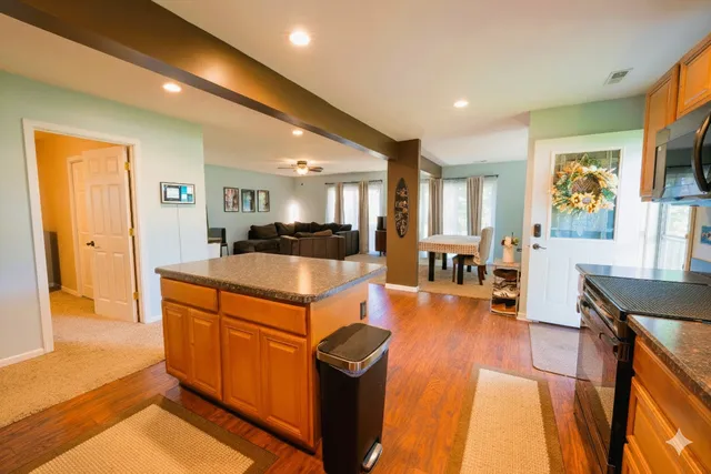 a kitchen with stainless steel appliances granite countertop a refrigerator a stove top oven a sink and dishwasher
