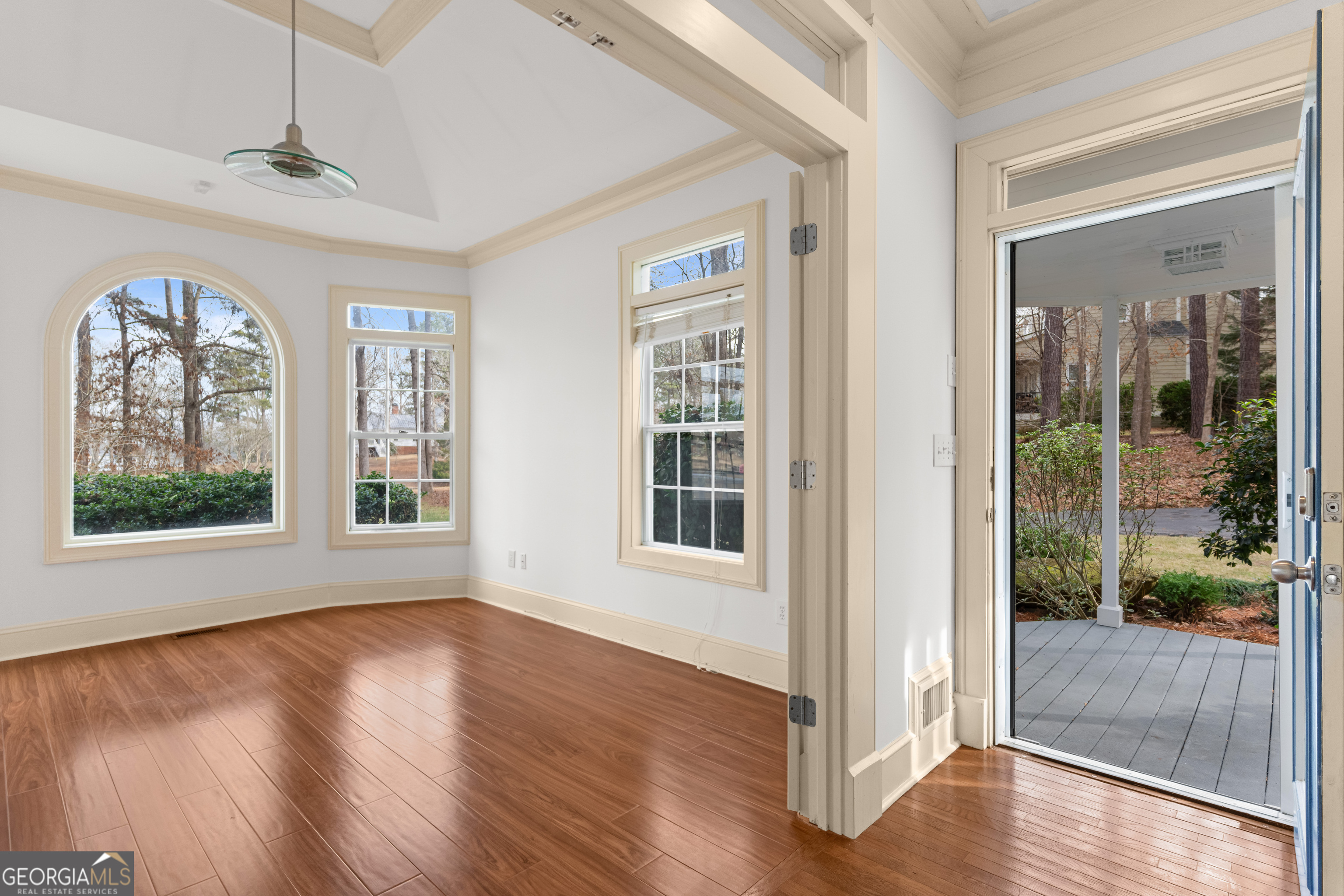 1010 Plum Orchard Road Greensboro, GA 30642 - Photo 13 of 85 a view of an empty room with wooden floor and a window