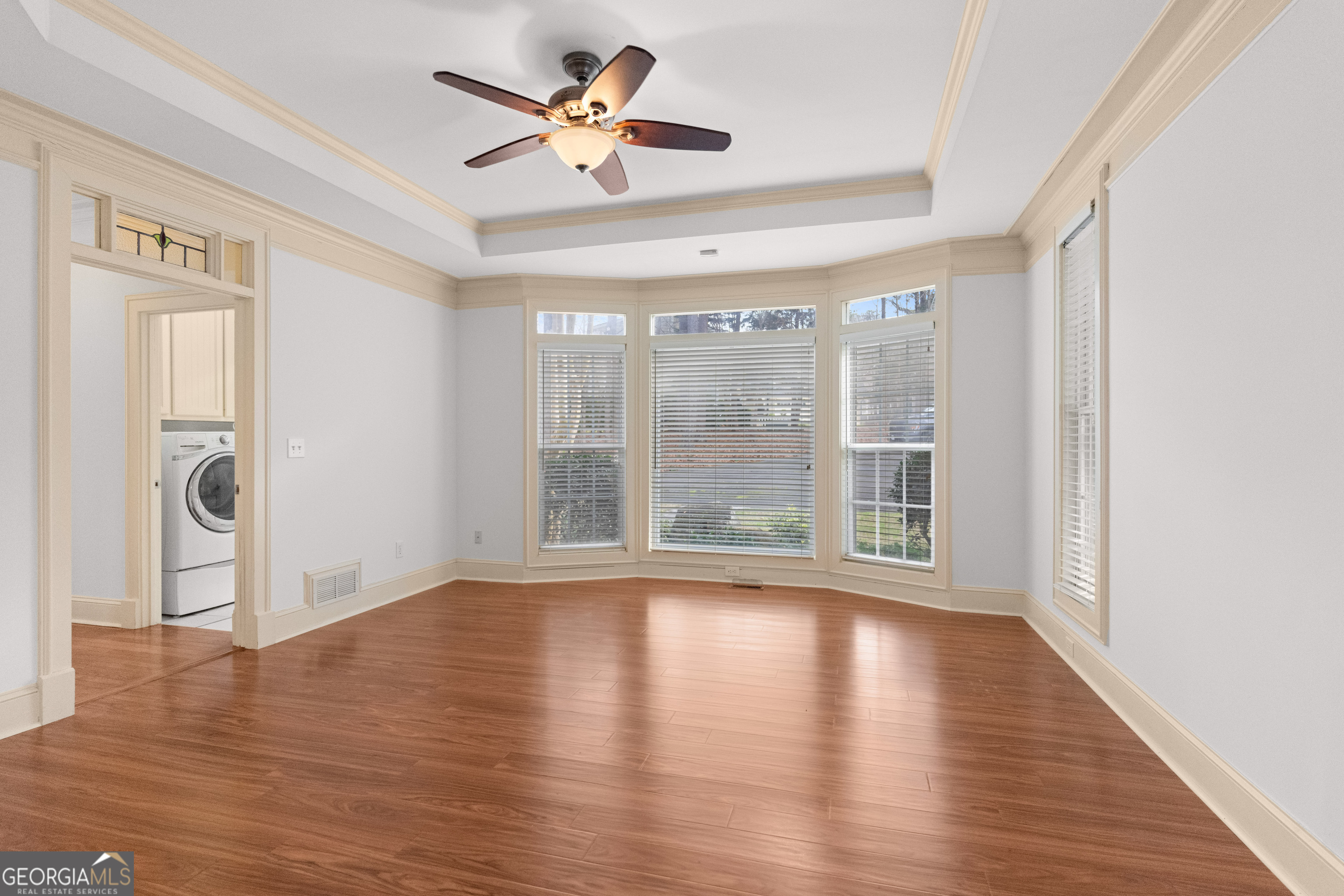1010 Plum Orchard Road Greensboro, GA 30642 - Photo 18 of 85 a view of an empty room with a window and wooden floor