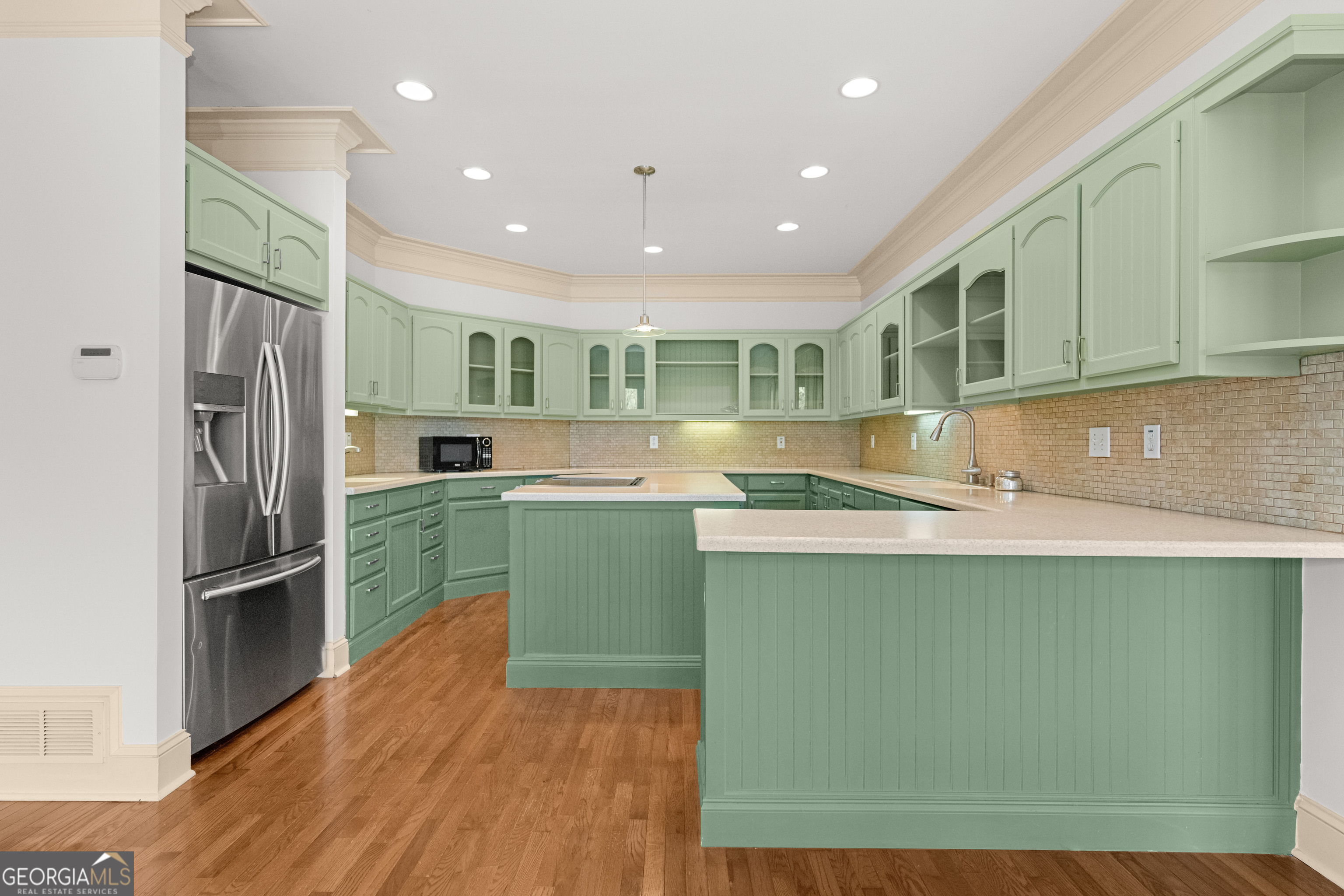 1010 Plum Orchard Road Greensboro, GA 30642 - Photo 23 of 85 a kitchen with kitchen island a counter top space a sink stainless steel appliances and cabinets