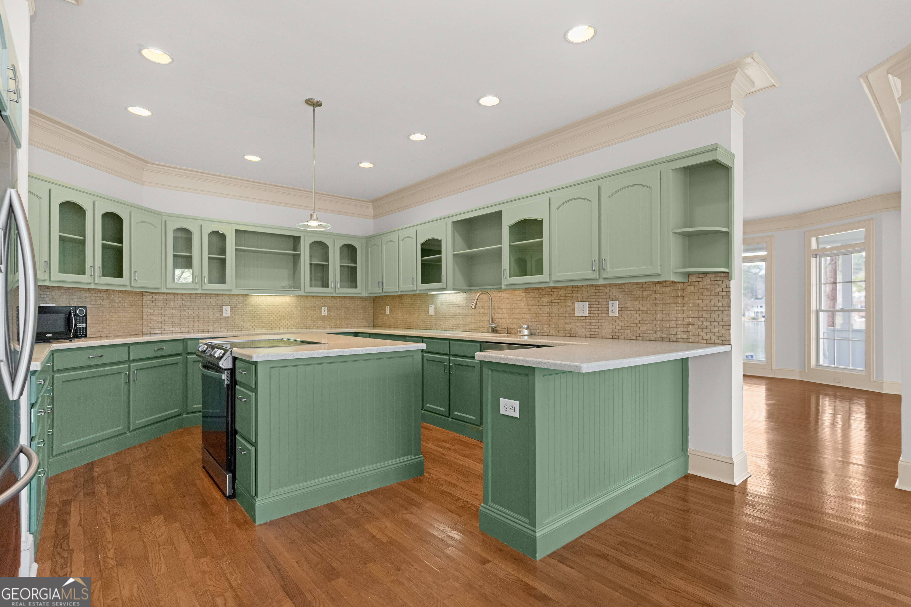 1010 Plum Orchard Road Greensboro, GA 30642 - Photo 25 of 85 a kitchen with kitchen island granite countertop a sink and wooden floors