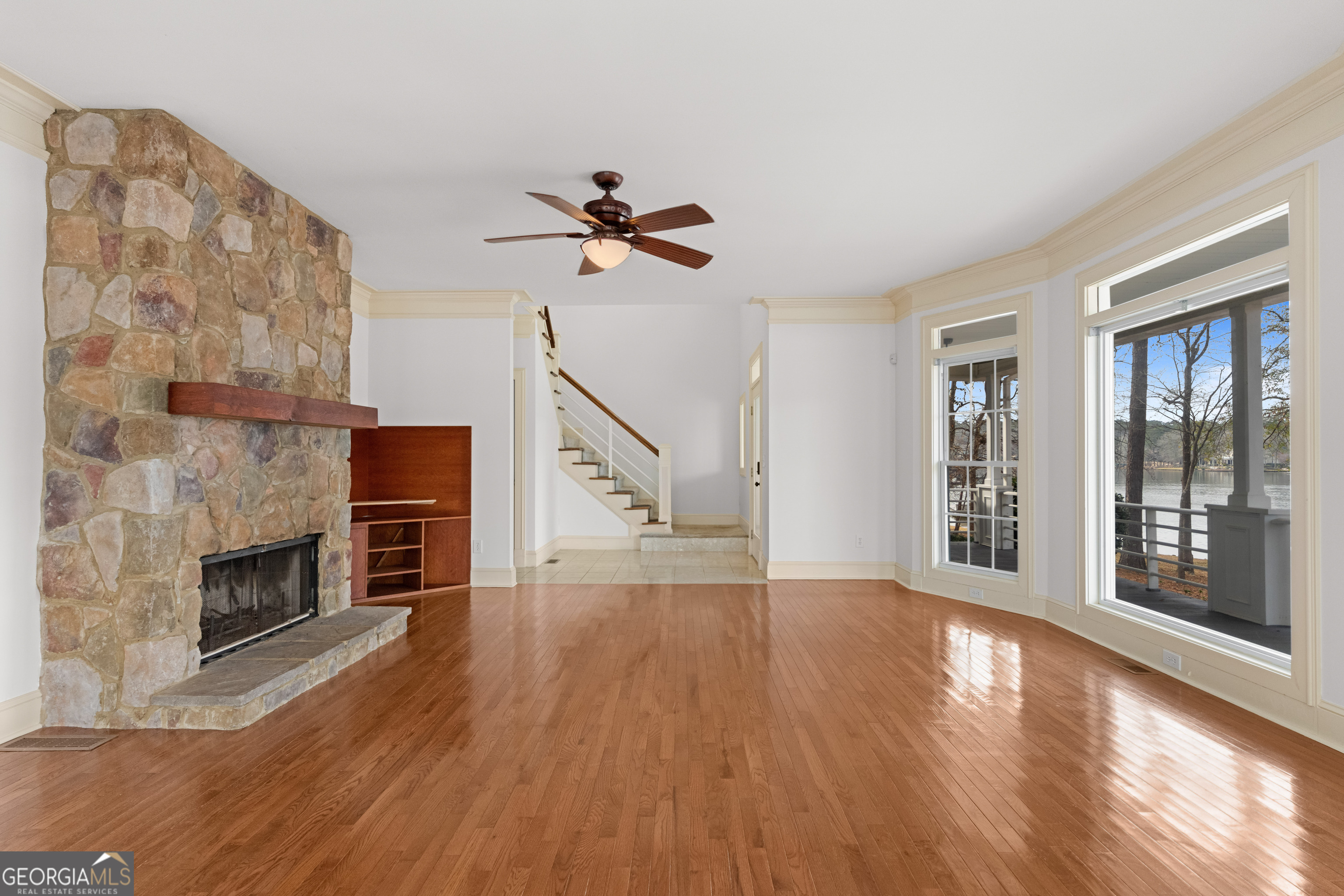 1010 Plum Orchard Road Greensboro, GA 30642 - Photo 33 of 85 a view of main area fire place window and wooden floor