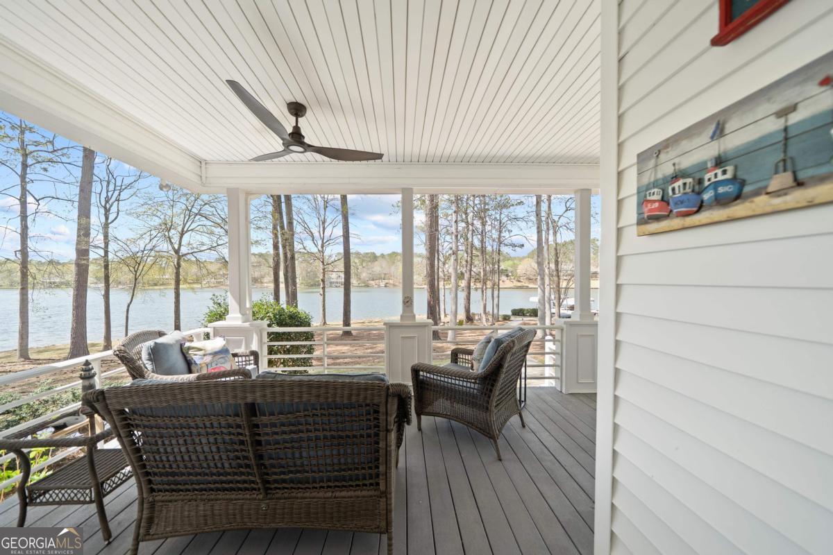 1010 Plum Orchard Road Greensboro, GA 30642 - Photo 62 of 85 a dining room with furniture large windows and a chandelier